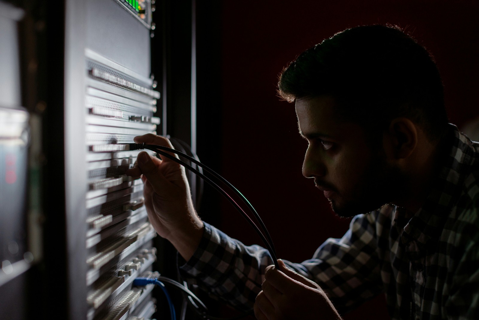 Engineer working at a network equipment rack